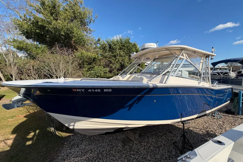 Slide: The Image of 2009 Grady-White Tournament 307 boat with blue hull, parked outdoors. - 37