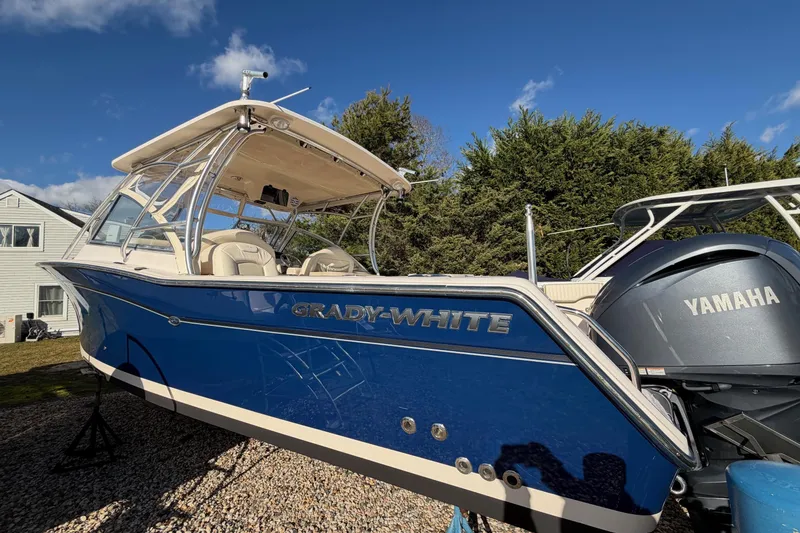 Slide: The Image of 2009 Grady-White Tournament 307 boat with Yamaha engine, parked outdoors under blue sky. - 39