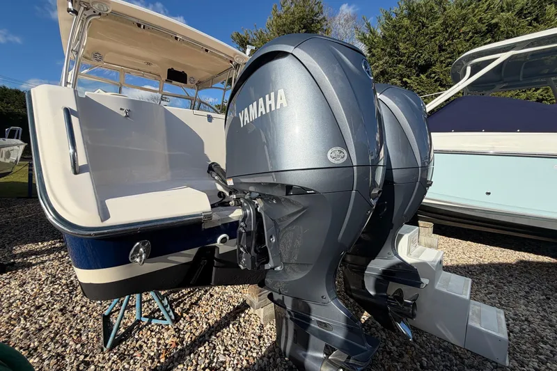 Slide: The Image of 2009 Grady-White Tournament 307 with Yamaha outboard engines, parked on gravel. - 4