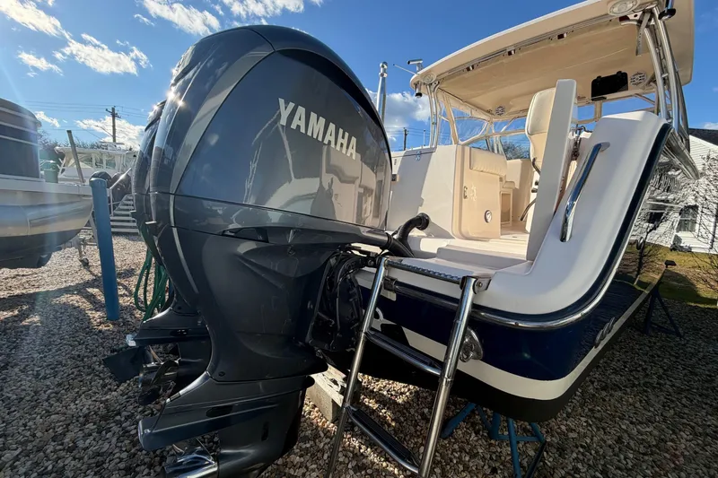 Slide: The Image of 2009 Grady-White Tournament 307 boat with Yamaha outboard engine, docked on gravel. - 5