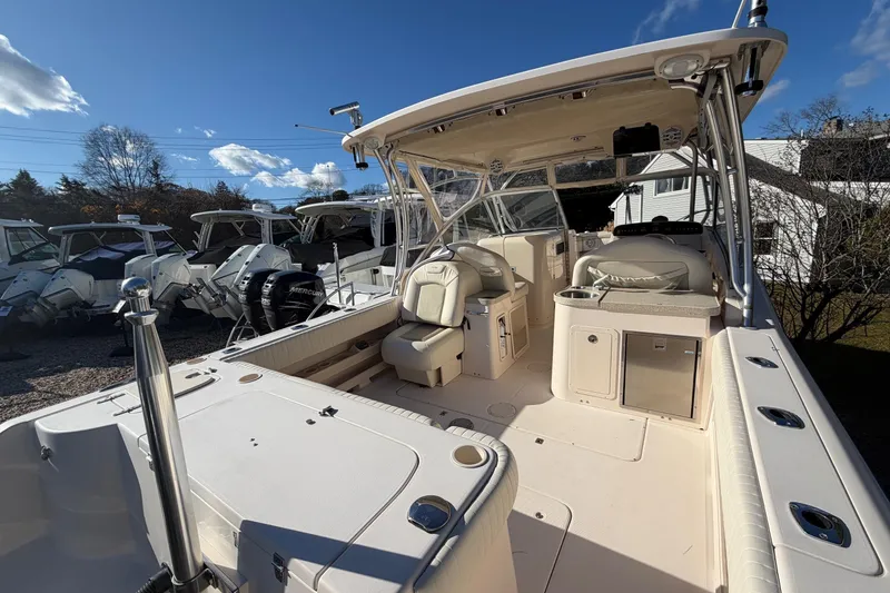 Slide: The Image of 2009 Grady-White Tournament 307 boat interior with seating and storage under clear blue sky. - 9