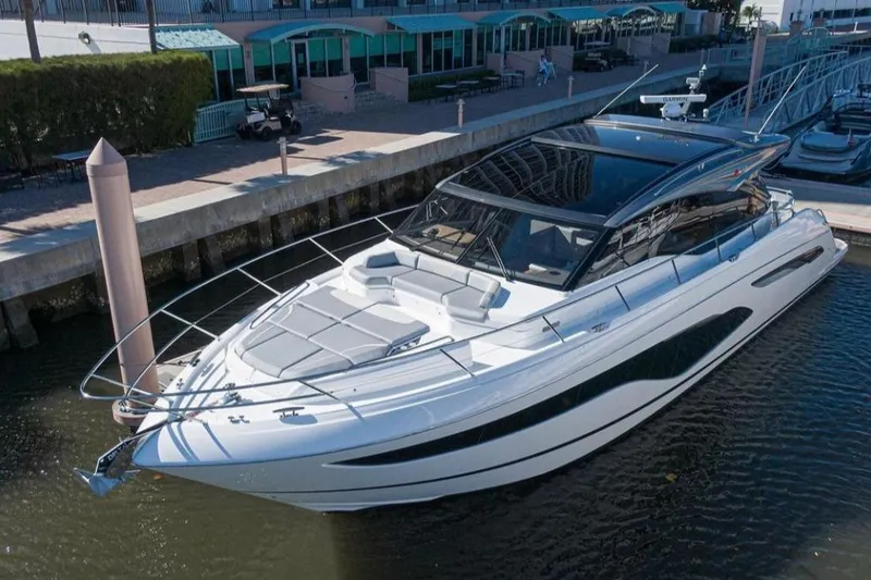 Slide: The Image of Luxurious 2019 Princess V60 yacht docked at a marina, showcasing sleek design. - 5