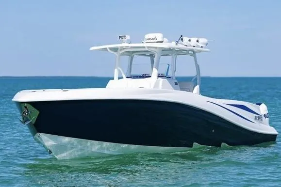 Slide: The Image of 2012 Deep Impact 399 Sport boat cruising on clear blue water. - 2