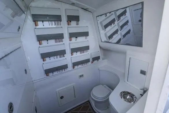 Slide: The Image of Interior of 2012 Deep Impact 399 Sport boat with bathroom and electrical panel. - 26