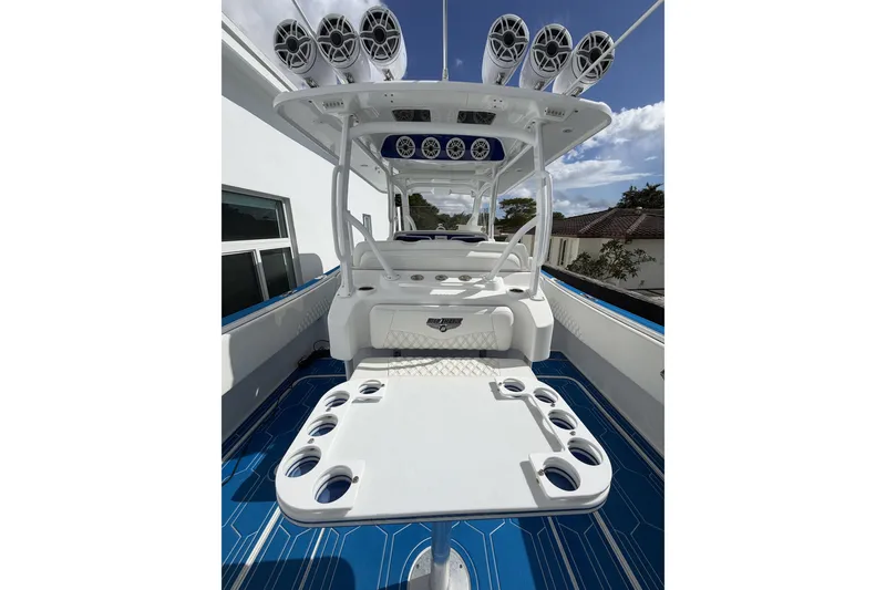 Slide: The Image of 2012 Deep Impact 399 Sport boat interior with speakers and seating, featuring a sleek design. - 7