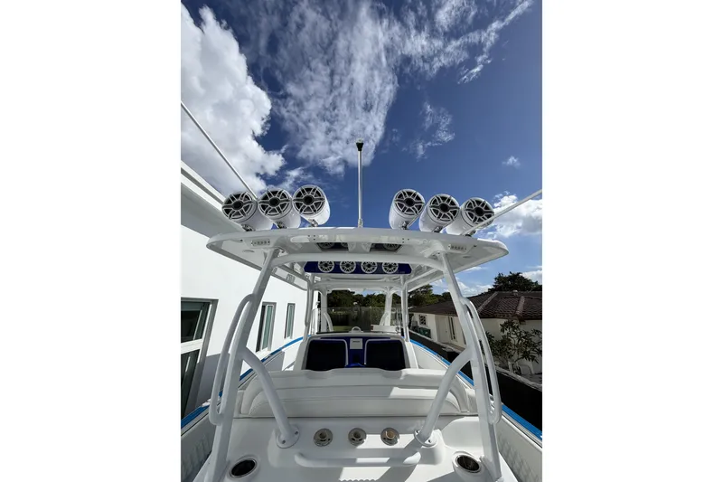 Slide: The Image of 2012 Deep Impact 399 Sport boat with speakers, clear sky background. - 9