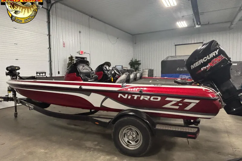 Slide: The Image of 2014 Nitro Z-7 boat with Mercury Pro XS engine in a garage setting. - 2