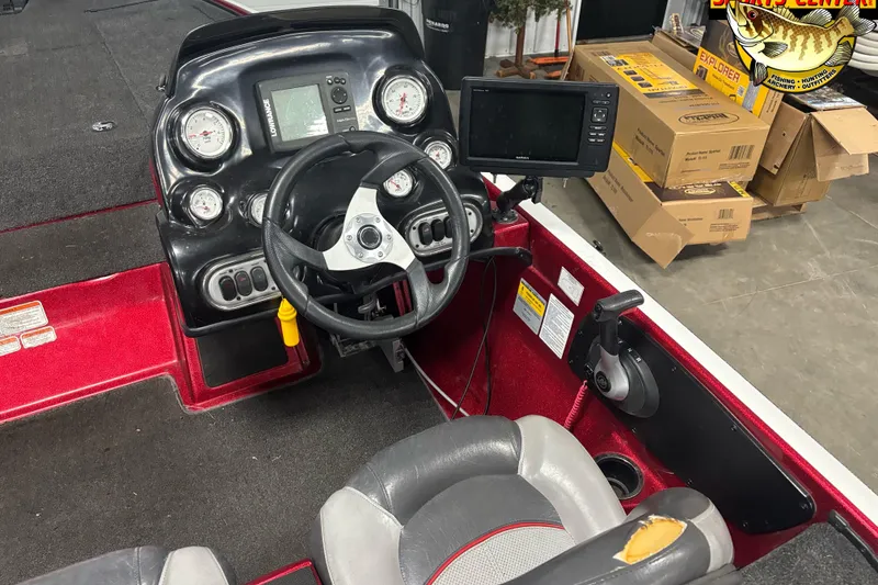 Slide: The Image of 2014 Nitro Z-7 boat dashboard with steering wheel, gauges, and navigation system. - 5