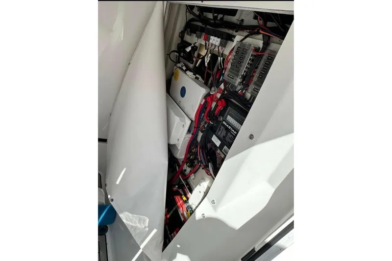 Slide: The Image of 2023 Sportsman Masters 267 Bay Boat electrical compartment with wiring and components. - 20