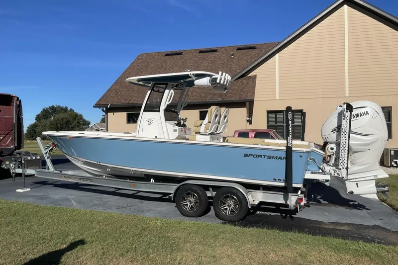 Slide: The Image of 2023 Sportsman Masters 267 Bay Boat on trailer, parked near a house. - 3