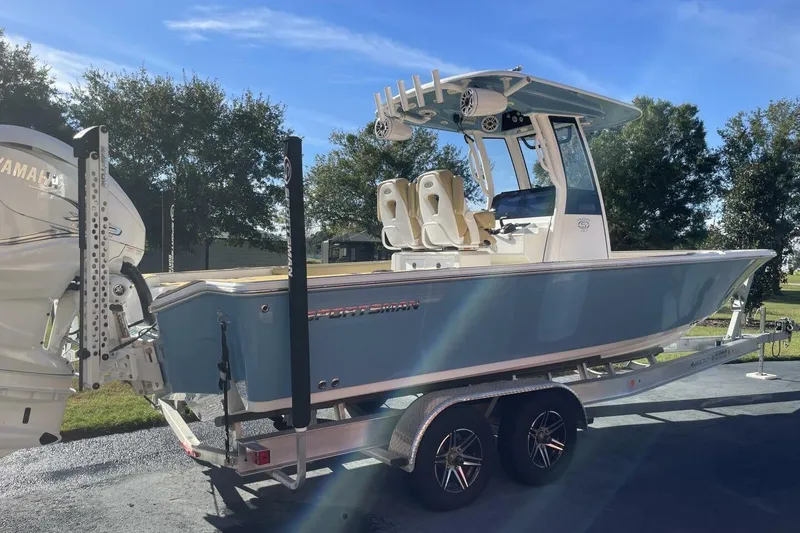 Slide: The Image of 2023 Sportsman Masters 267 Bay Boat on trailer, featuring Yamaha engine, under clear blue sky. - 5