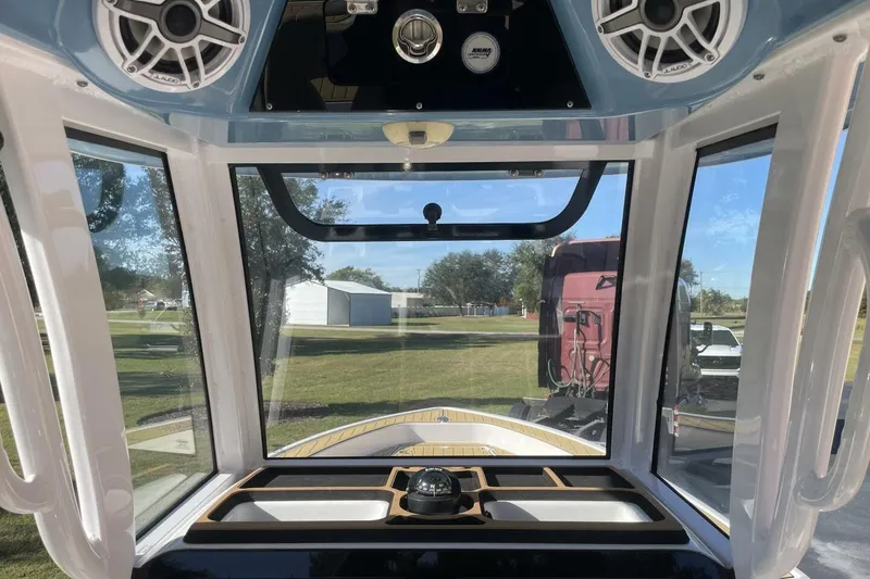 Slide: The Image of 2023 Sportsman Masters 267 Bay Boat interior with speakers and windshield view. - 26