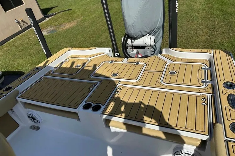 Slide: The Image of 2023 Sportsman Masters 267 Bay Boat deck with tan and white detailing. - 8