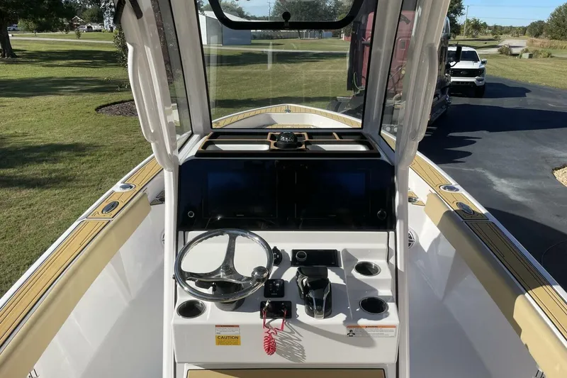 Slide: The Image of 2023 Sportsman Masters 267 Bay Boat cockpit with steering wheel and control panel. - 38