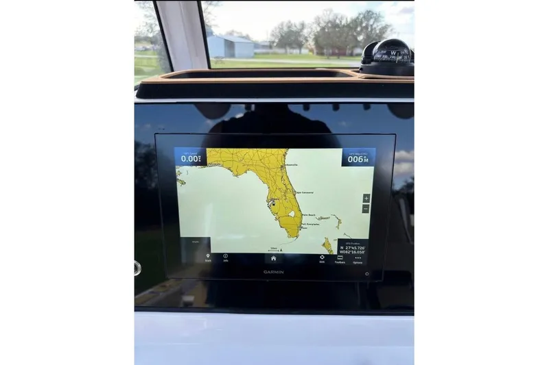 Slide: The Image of 2023 Sportsman Masters 267 Bay Boat GPS display showing Florida map on Garmin screen. - 14