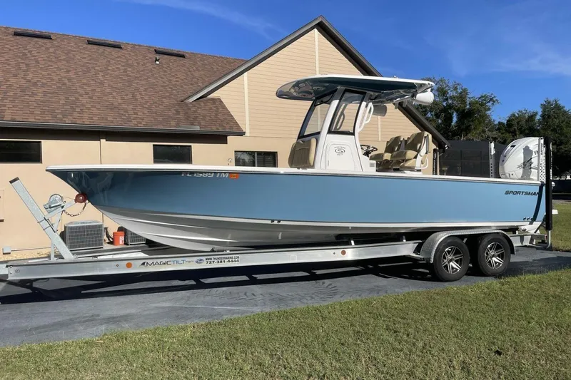 Slide: The Image of 2023 Sportsman Masters 267 Bay Boat on trailer, parked near a house. - 4