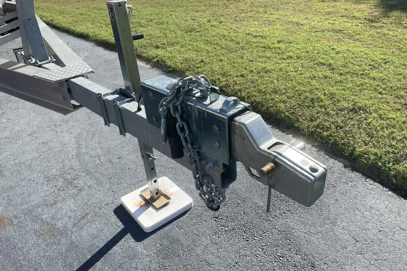 Slide: The Image of Trailer hitch of 2023 Sportsman Masters 267 Bay Boat on asphalt, secured with chains. - 47