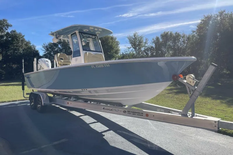 Slide: The Image of 2023 Sportsman Masters 267 Bay Boat on trailer, parked outdoors under clear sky. - 1