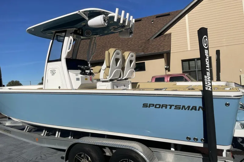 Slide: The Image of 2023 Sportsman Masters 267 Bay Boat in light blue on trailer, side view. - 2