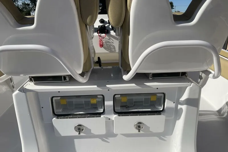 Slide: The Image of 2023 Sportsman Masters 267 Bay Boat interior with dual seats and storage compartments. - 17