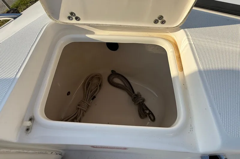 Slide: The Image of Open storage compartment on 2008 Scout 205 Sportfish boat with ropes inside. - 12