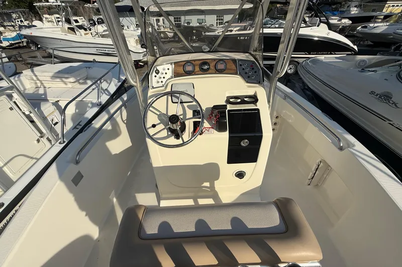 Slide: The Image of 2008 Scout 205 Sportfish boat cockpit with steering wheel and control panel. - 14