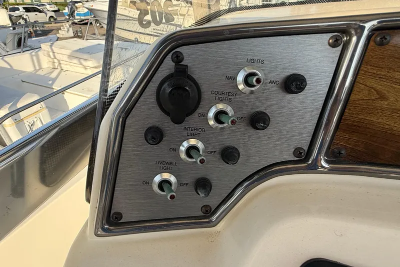 Slide: The Image of Control panel of a 2008 Scout 205 Sportfish boat with various light switches. - 18