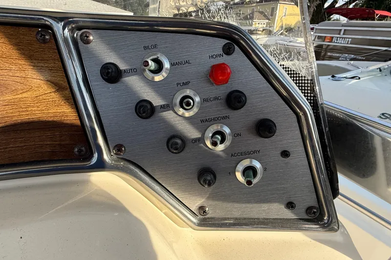 Slide: The Image of Control panel of a 2008 Scout 205 Sportfish boat with various switches and buttons. - 20