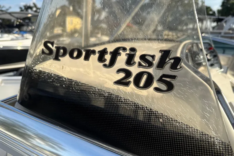 Slide: The Image of 2008 Scout 205 Sportfish boat logo on windshield, close-up view. - 24