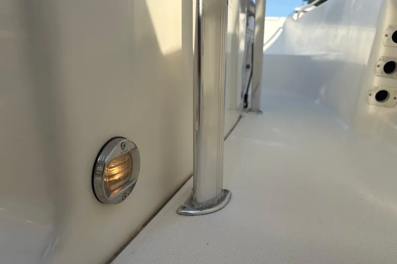 Slide: The Image of 2008 Scout 205 Sportfish boat interior with chrome details and side light. - 25