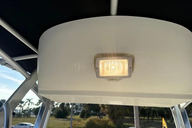 Slide: The Image of 2008 Scout 205 Sportfish boat interior light fixture with canopy and outdoor view. - 27