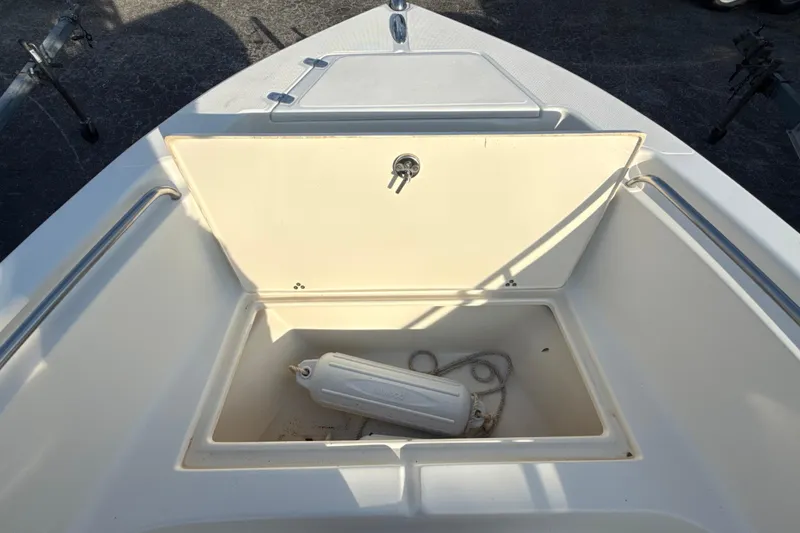 Slide: The Image of 2008 Scout 205 Sportfish boat storage compartment with fender and rope. - 29