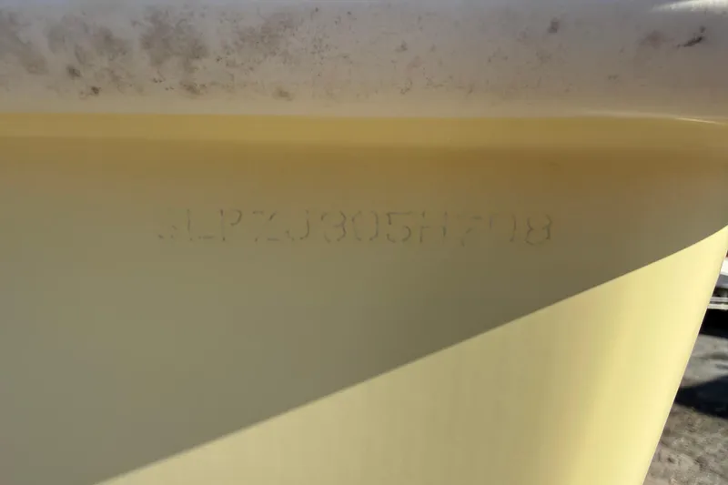 Slide: The Image of 2008 Scout 205 Sportfish boat hull identification number on yellow surface. - 33
