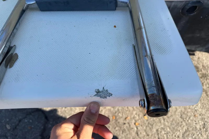 Slide: The Image of Close-up of a damaged 2008 Scout 205 Sportfish boat ladder with visible crack. - 7