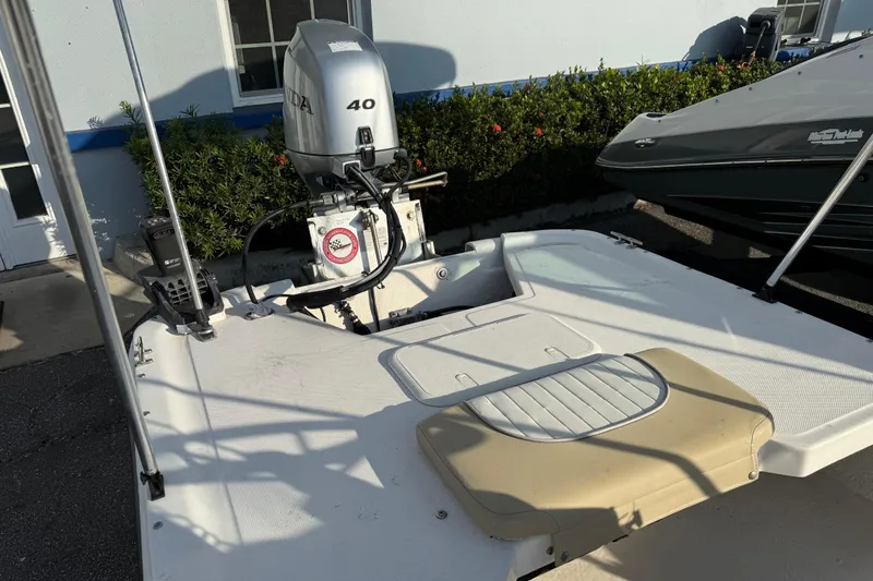 Slide: The Image of 2018 Sundance K16CC boat with Honda 40 outboard motor, parked near a building. - 10