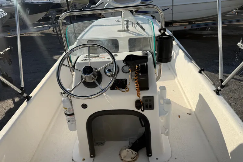 Slide: The Image of 2018 Sundance K16CC boat interior with steering wheel and control panel. - 12