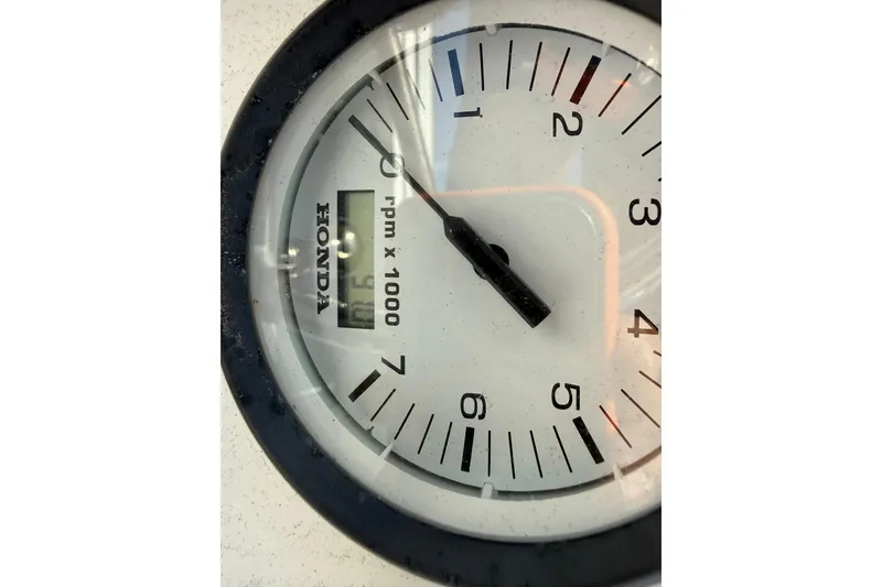 Slide: The Image of Close-up of a Honda tachometer showing 900 RPM on a Sundance K16CC, 2018 model. - 13
