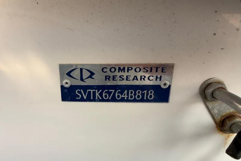 Slide: The Image of Metal plate on Sundance K16CC 2018 boat, displaying "Composite Research" and serial number. - 16