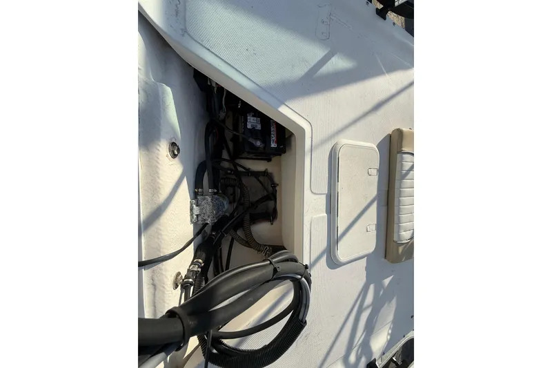 Slide: The Image of 2018 Sundance K16CC boat interior showing wiring and storage compartments. - 9