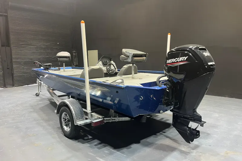 Slide: The Image of 2021 Lund 1875 Renegade boat with Mercury engine on trailer in garage. - 3