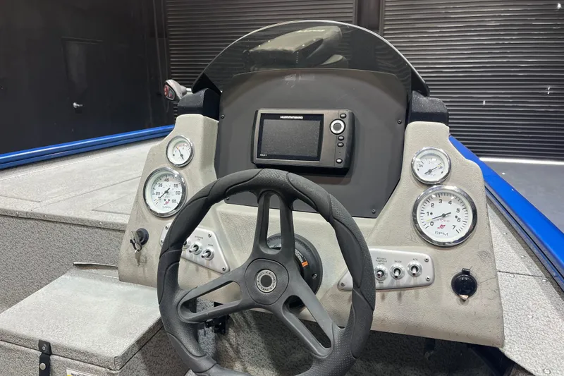 Slide: The Image of 2021 Lund 1875 Renegade boat dashboard with steering wheel and gauges. - 5