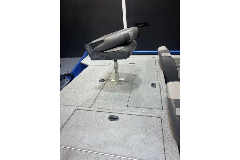 Slide: The Image of 2021 Lund 1875 Renegade boat interior with gray seating and storage compartments. - 7