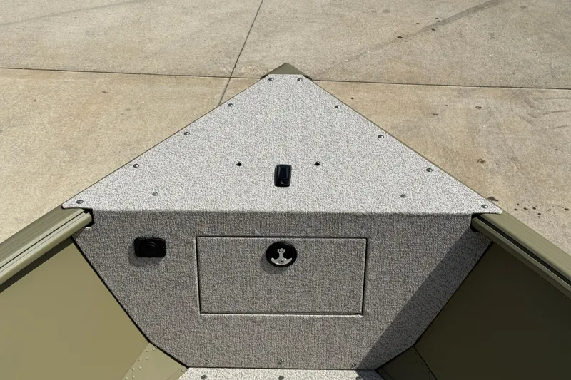 Slide: The Image of 2025 Lund 1875 Alaskan SS boat interior, featuring a textured deck and storage compartment. - 12