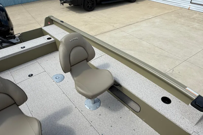 Slide: The Image of 2025 Lund 1875 Alaskan SS boat interior with beige seating and spacious deck. - 17