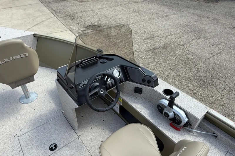Slide: The Image of 2025 Lund 1875 Alaskan SS boat interior with steering console and seating. - 19