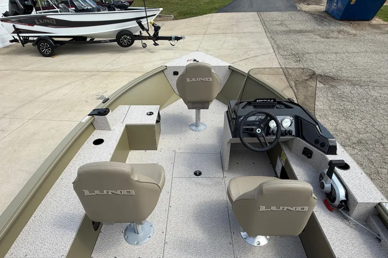 Slide: The Image of 2025 Lund 1875 Alaskan SS boat interior with steering console and seating. - 22