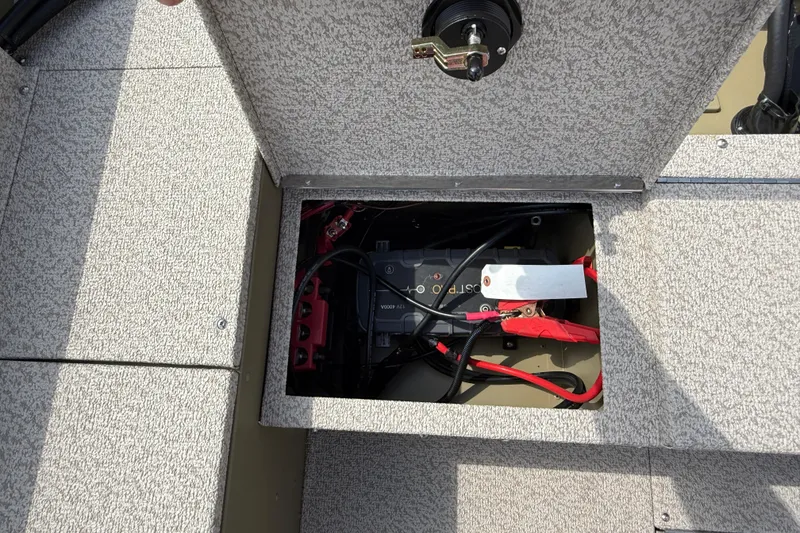 Slide: The Image of 2025 Lund 1875 Alaskan SS boat battery compartment with wiring and connections. - 25