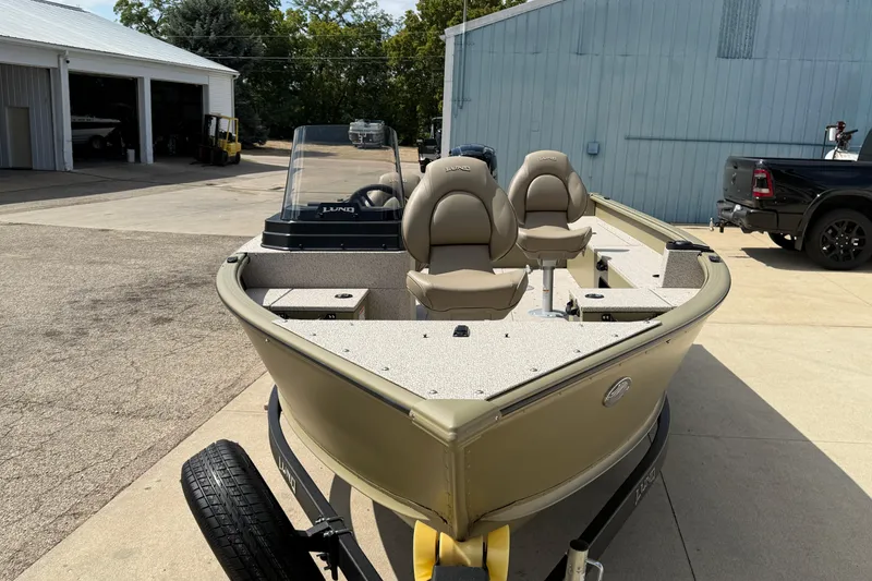 Slide: The Image of 2025 Lund 1875 Alaskan SS boat on trailer, parked outside a garage. - 3