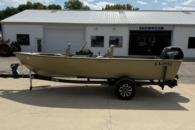 Slide: The Image of 2025 Lund 1875 Alaskan SS boat on trailer outside showroom. - 5