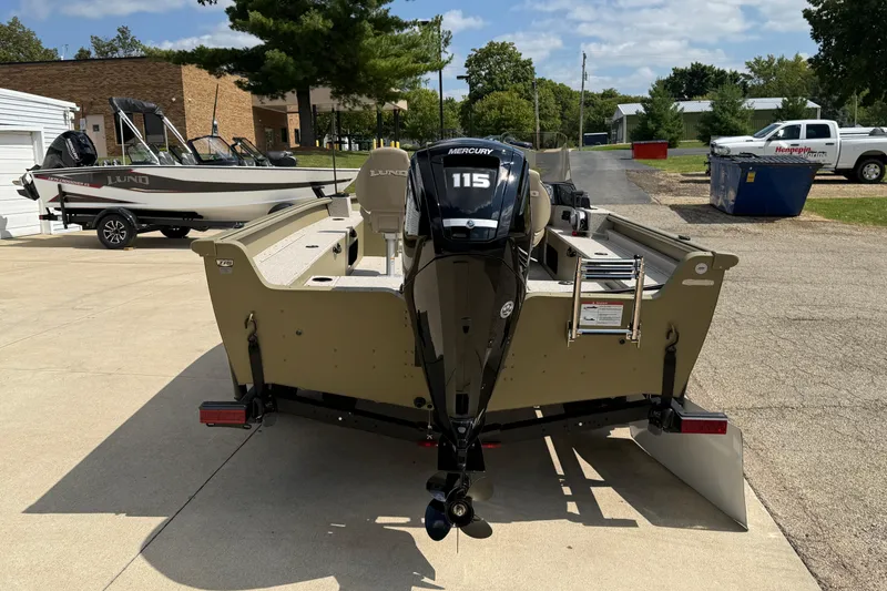 Slide: The Image of 2025 Lund 1875 Alaskan SS boat with Mercury 115 engine, parked outdoors. - 7